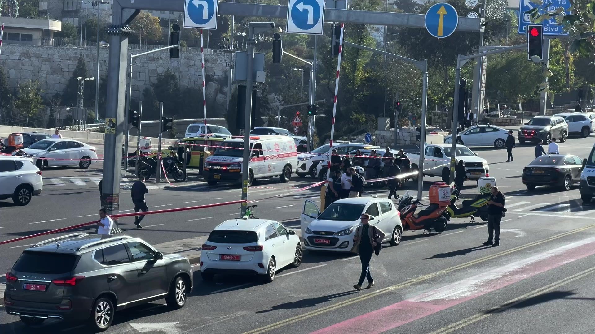 Security forces remove car used during a gun attack on bus stop in Jerusalem