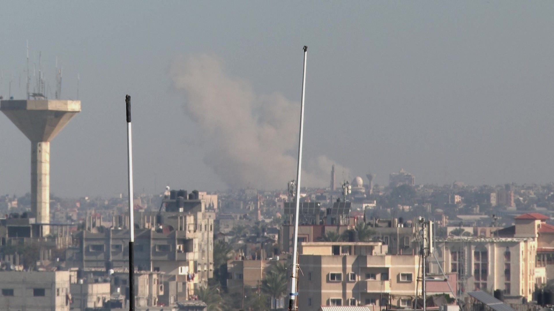 Smoke billows over Khan Yunis following Israeli strikes, seen from Rafah