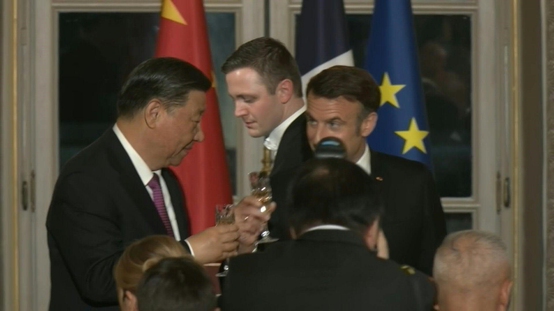 Macron and Xi toast at a state dinner at the Elysee Palace