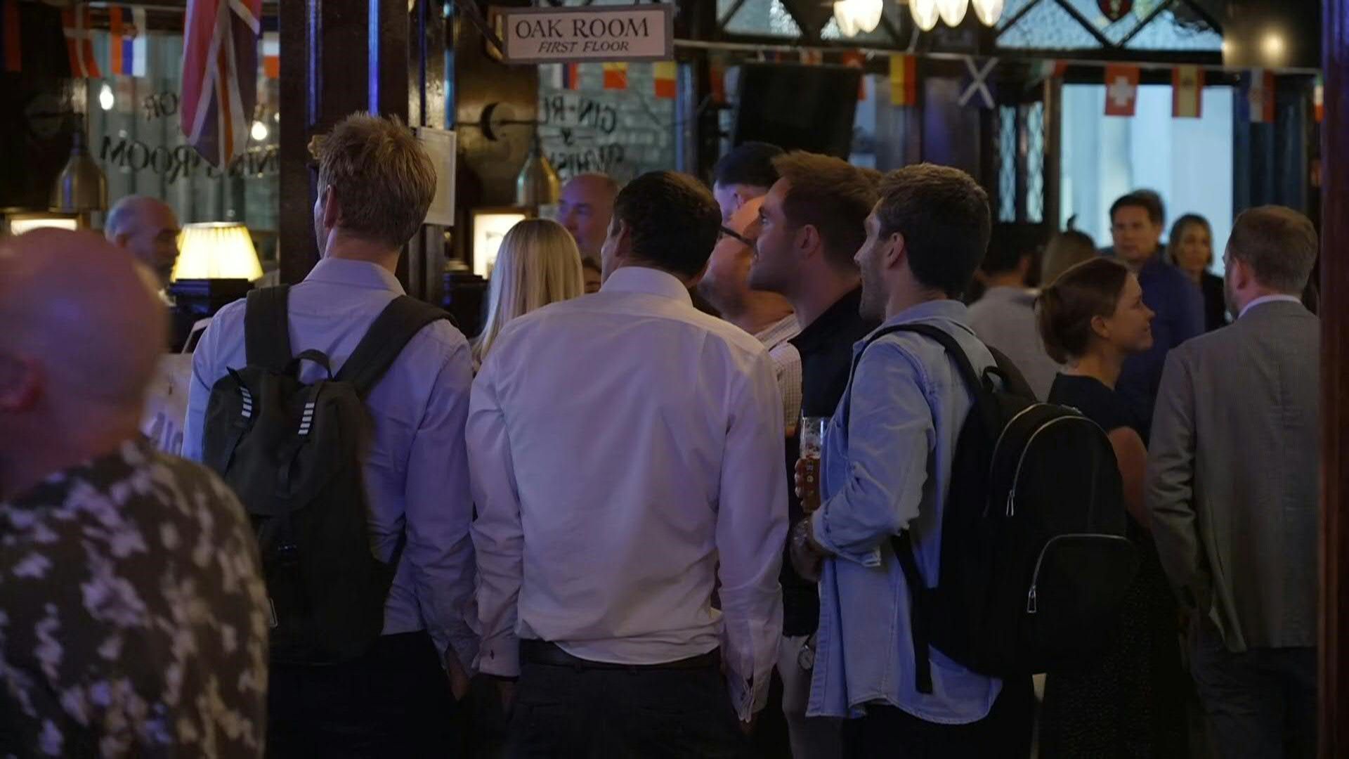 Londoners watch general election exit poll at the pub