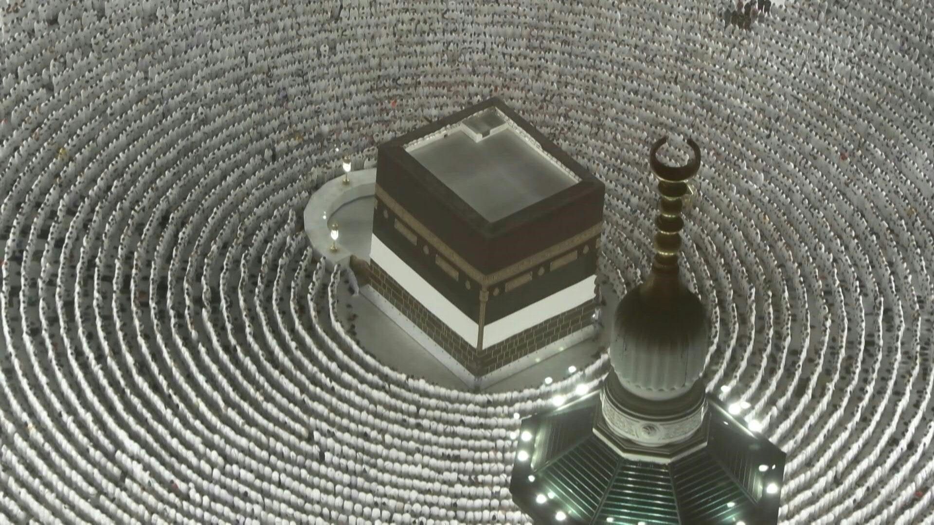 Pilgrims pray around the Kaaba in Mecca at night