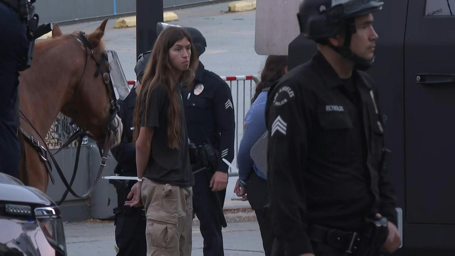 Video: Police detain people as second night of curfew begins in Los Angeles