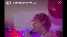 Machine Gun Kelly bleeds after smashing champagne flute on his head