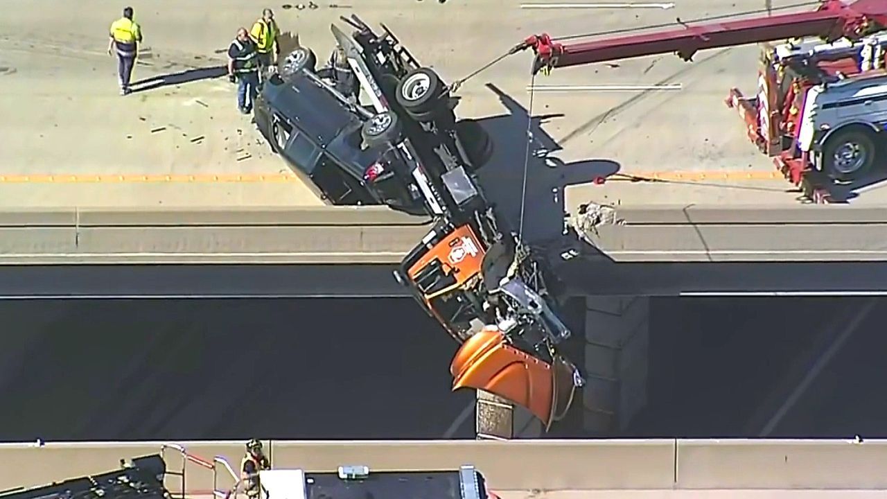 Driver rescued after crash leaves tow truck hanging off Texas bridge