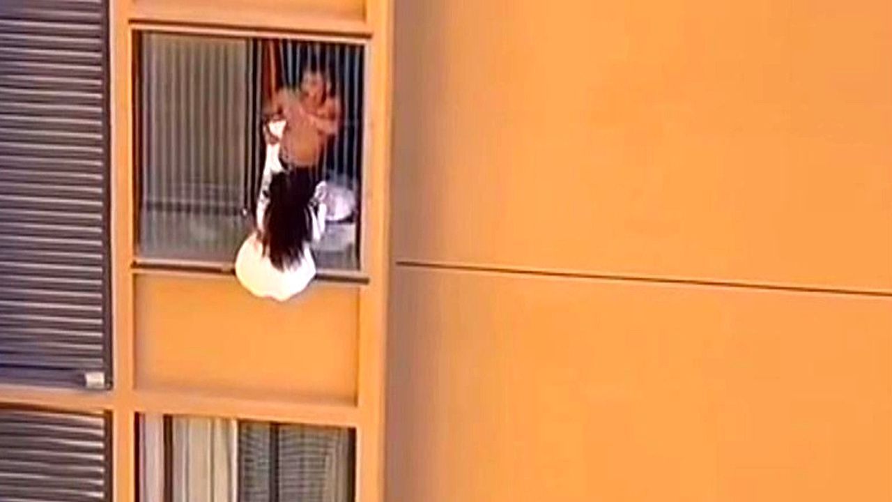 Video: Mistress nearly falls to her death while hiding from lover's wife on 10th-floor window