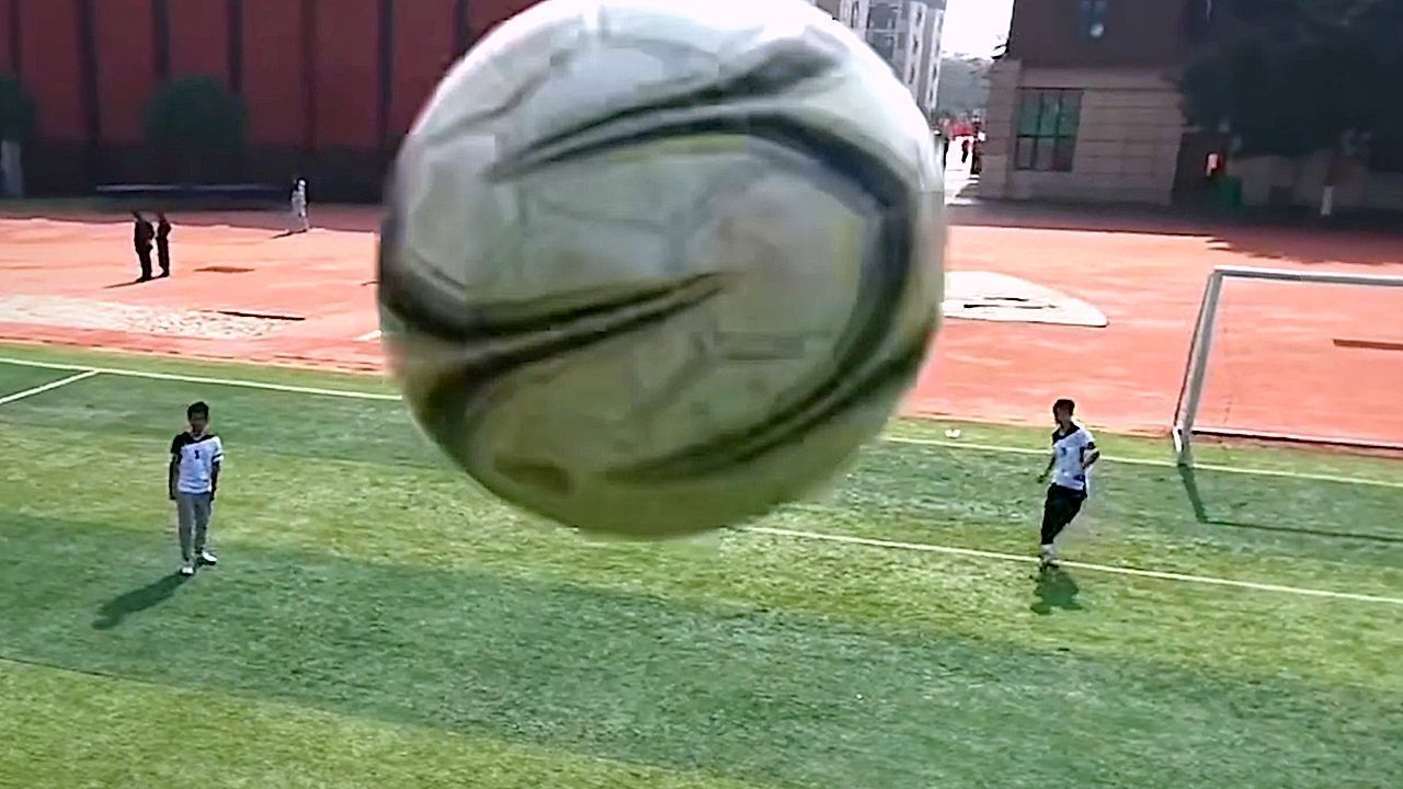 Youngster kicks ball straight at drone camera