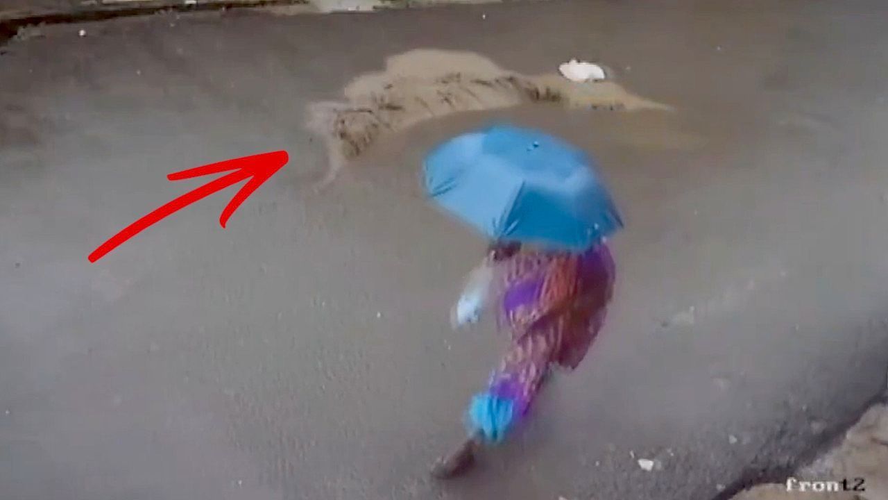 Video: Bizarre moment road rips open as water gushes out and floods street