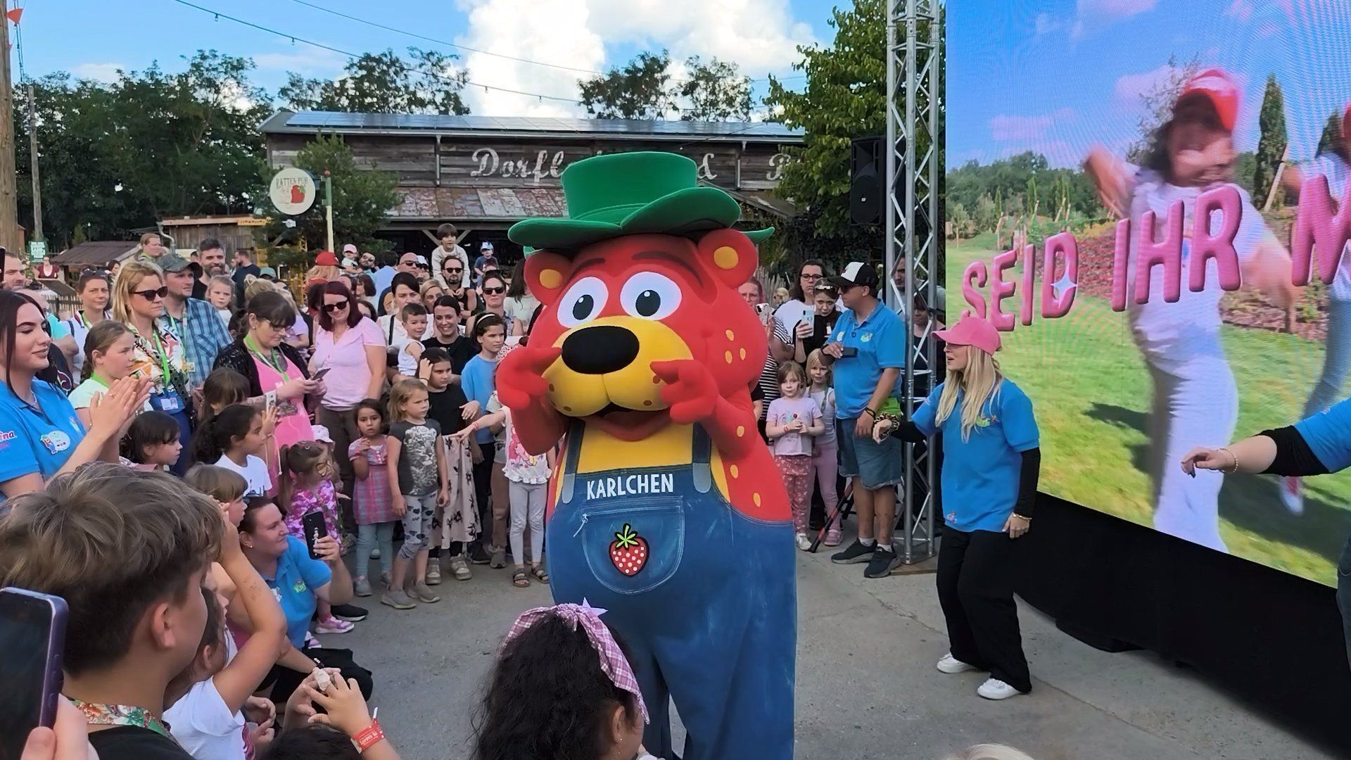 1. great summer evening at Karls amusement park with highlights - mascot performs song and strawberry cake eating contest